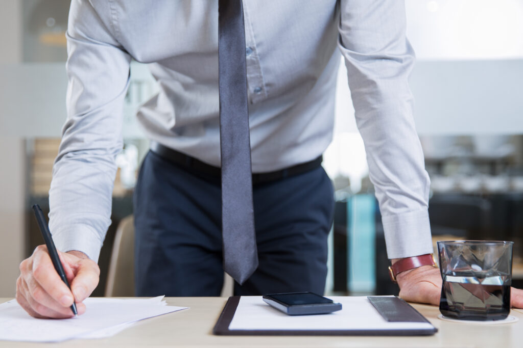 successful businessman signing contract in office